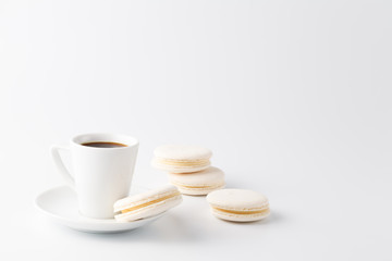 Fototapeta na wymiar Minimalistic shot of espresso cup with one white macaroon