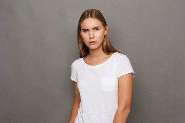 Young woman studio headshot portrait on gray background