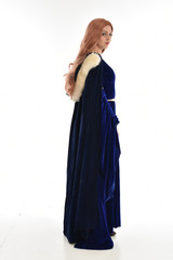 full length portrait of girl wearing long blue velvet gown and fur lined cloak, standing pose...