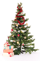 Decorated Christmas tree with heap of gift boxes near it on white background