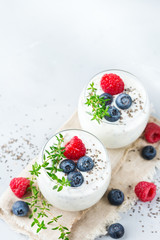 Healthy vegan white chia pudding with berries and green thyme