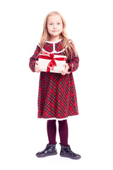 Isolated portrait of cute blonde little girl in checkered red dress holding gift box