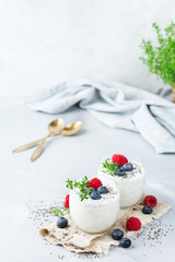 Healthy vegan white chia pudding with berries and green thyme