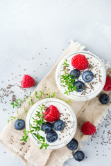 Healthy vegan white chia pudding with berries and green thyme