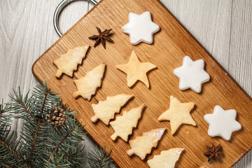 Fototapeta na wymiar Gingerbread cookies in Christmas tree and star shape on wooden board