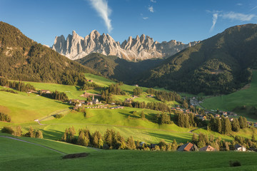 Small Italian mountain town of St. Magdalena in Val di Funes at sunset