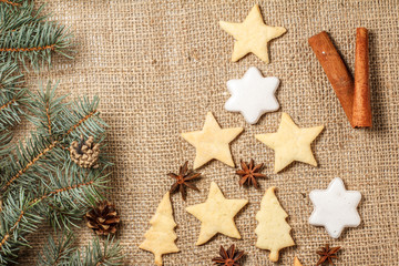 Gingerbread cookies in Christmas tree and star shape on sackcloth