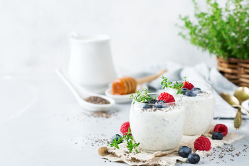 Healthy vegan white chia pudding with berries and green thyme