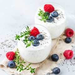 Healthy vegan white chia pudding with berries and green thyme