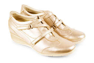 Golden sport shoes isolated on white background