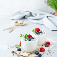 Healthy vegan white chia pudding with berries and green thyme