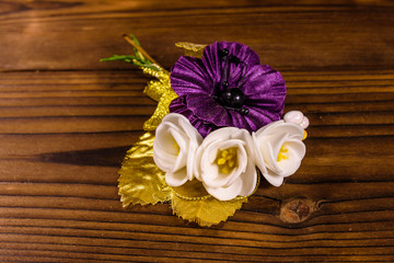 Beautiful multicolored brooch on a wooden table