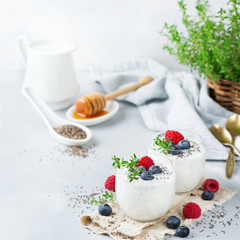 Healthy vegan white chia pudding with berries and green thyme