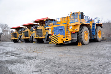 Tractor and three quarry dump trucks