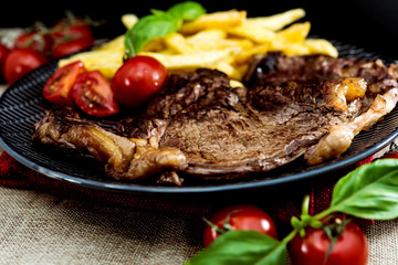 juicy steak beef meat with tomato and french fries