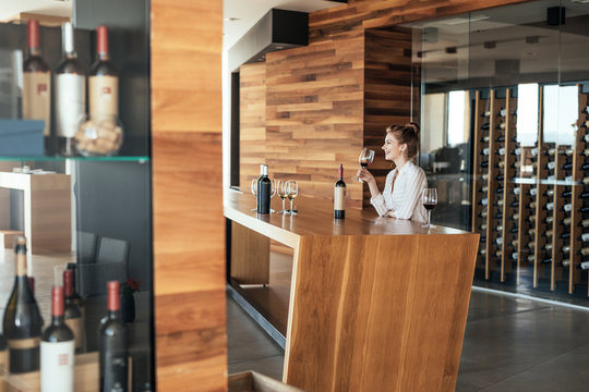 Woman enjoying wine tasting at winery