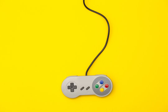 Fototapeta Retro computer gaming controller on a bright yellow background