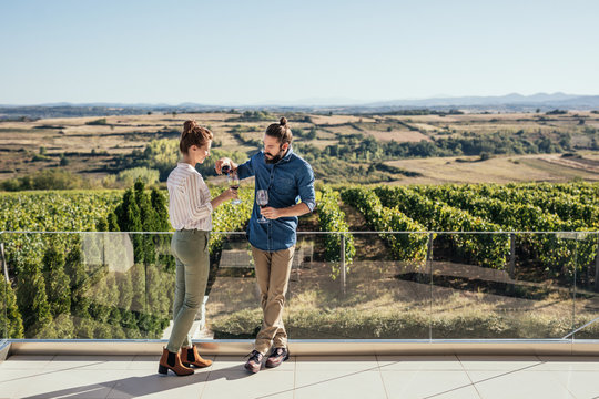Couple enjoying drinking wine at vineyard