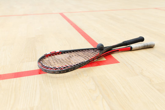 two squash rackets and ball