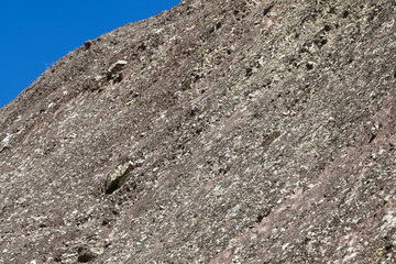 sunlit mountain with blue sky and selective focus