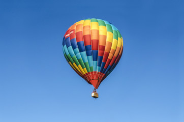 Naklejka premium Bright balloon with a mosaic pattern of red, yellow,green and blue colors in the sky over the capital of Armenia, in celebration of 