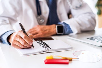 Senior doctor working at the office desk.