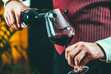 Pouring red wine from bottle