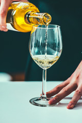 Pouring white wine from bottle