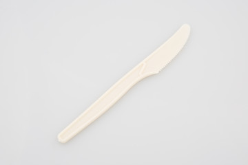 Single disposable plastic knife isolated over the white background