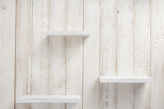 set of wooden shelves on wall background