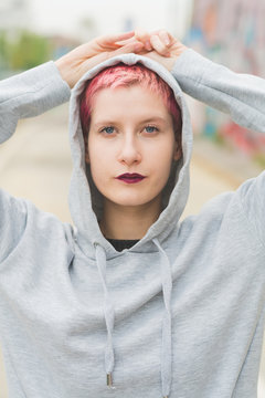 Portrait of young woman with pink hair
