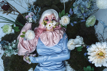 Beauty portrait of young woman wearing fashion dress with creative hairstyle and bright makeup.