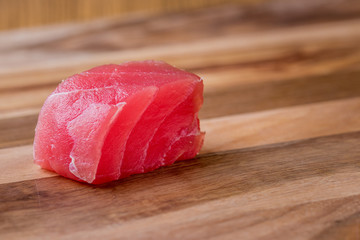 Fresh Tuna Fish Steak Sashimi and spice on wooden plate.