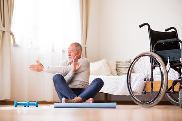 Senior man doing exercise at home.