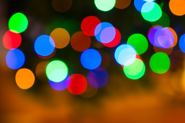 Fototapeta premium Christmas lights color bokeh - A bright multicolor bokeh background created by a set of de-focused Christmas lights.