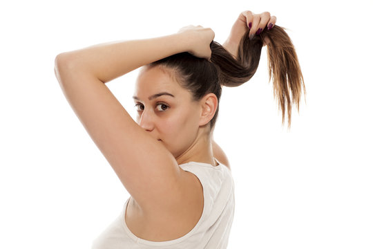 Back view of young woman tied her hair in ponytail