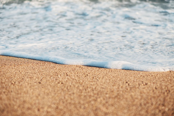 The Balearic sea in Spain. Soft Wave Of Blue Ocean On Sandy Beach. Background. Selective focus.Summer outdoor nature harmony. Summer holiday serenity.