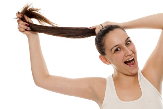 Portrait of young happy woman tied her hair in ponytail