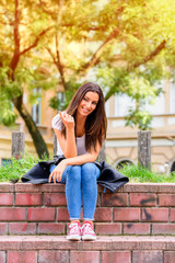 Obraz premium Portrait of a happy young woman being cheerful in a Park 