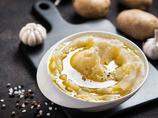 Mashed potatoes on dark concrete background