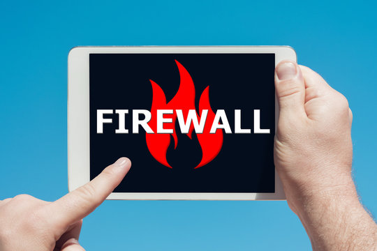 Man holding a tablet device pointing at an anti-spam, security firewall icon