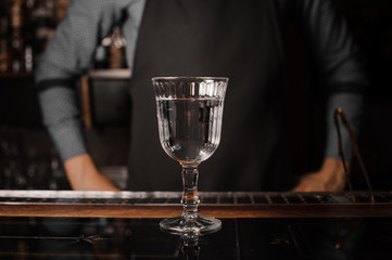 Cocktail glass filled with alcoholic drink on the bar counter