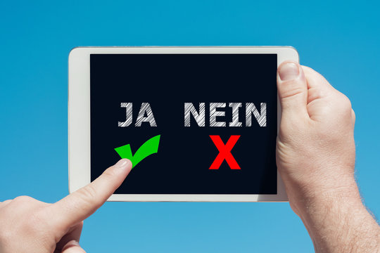 Man holding a tablet device with "yes no" icons as decision concept