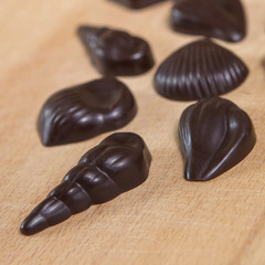 Homemade no sugar proper nutrition chocolate candies on a wooden background. Healthy food