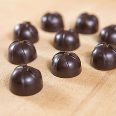 Homemade no sugar proper nutrition chocolate candies on a wooden background. Healthy food