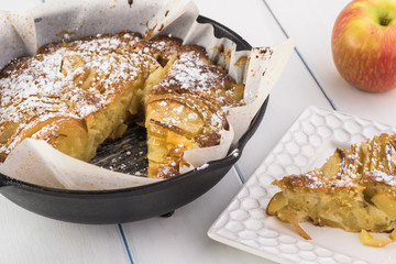 Fresh baked cardamom cognac apple cake in iron skillet.