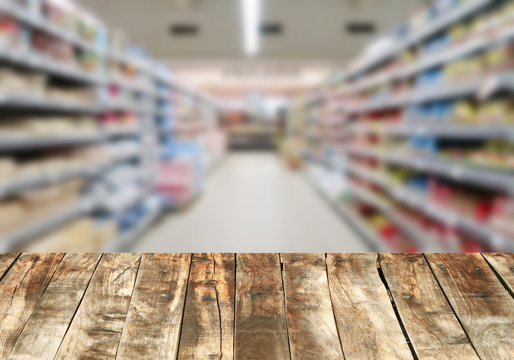 Wood board over blurred supermarket