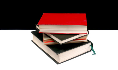 various colored books on a black and white background