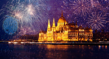 Fototapeta na wymiar celebrating New Year in the city - Budapest parliament with fireworks, Hungary
