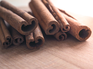 Cinnamon sticks on rustic wooden board

